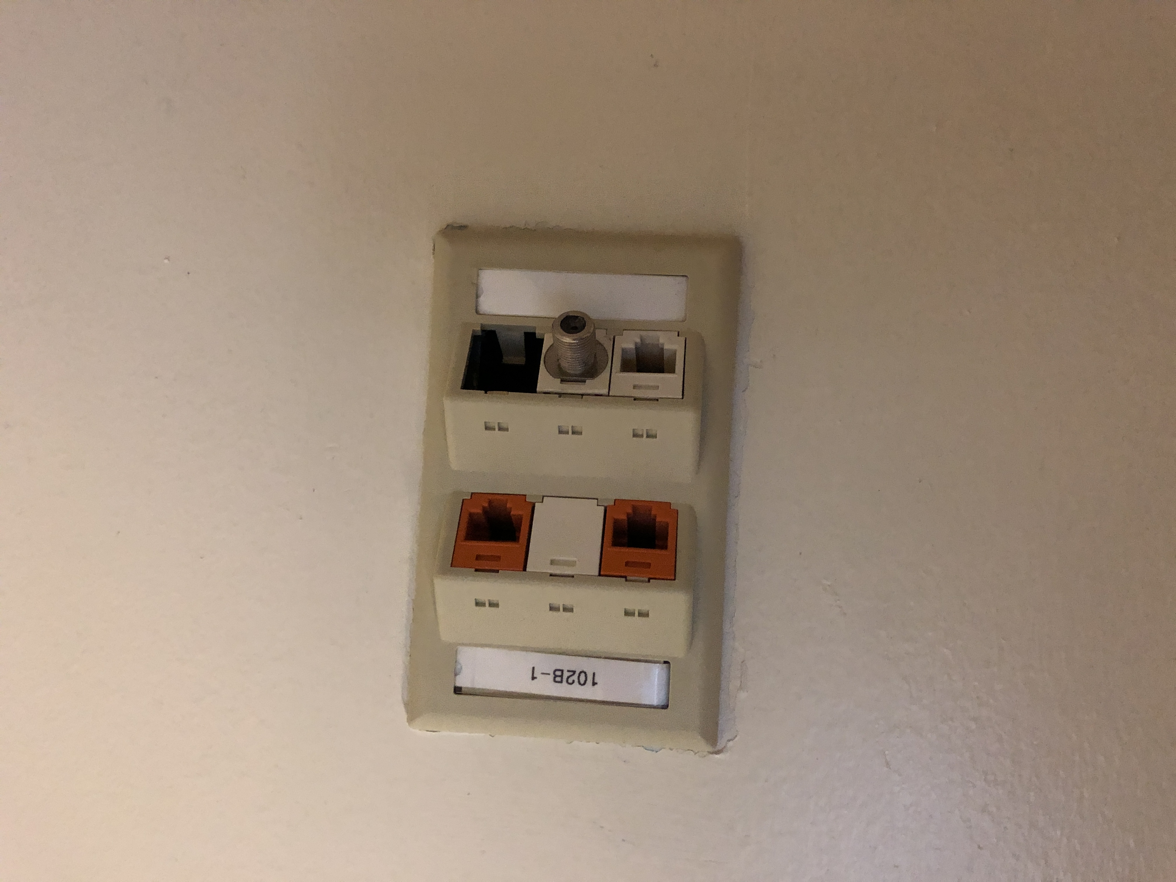 Network connection panel with orange and black connectors